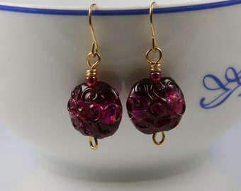 Flame worked lentil shape bead with 23.4 kt gold foil and black stringers in scroll design