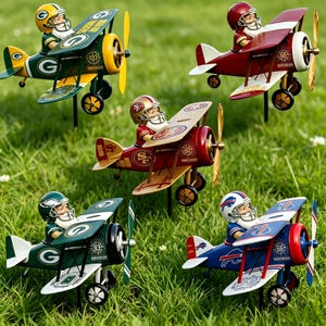 May include: A collection of decorative model airplanes, each featuring a football player pilot. The planes are painted in team colors, including green and gold, red and gold, and blue and red. The planes are set on metal stakes.