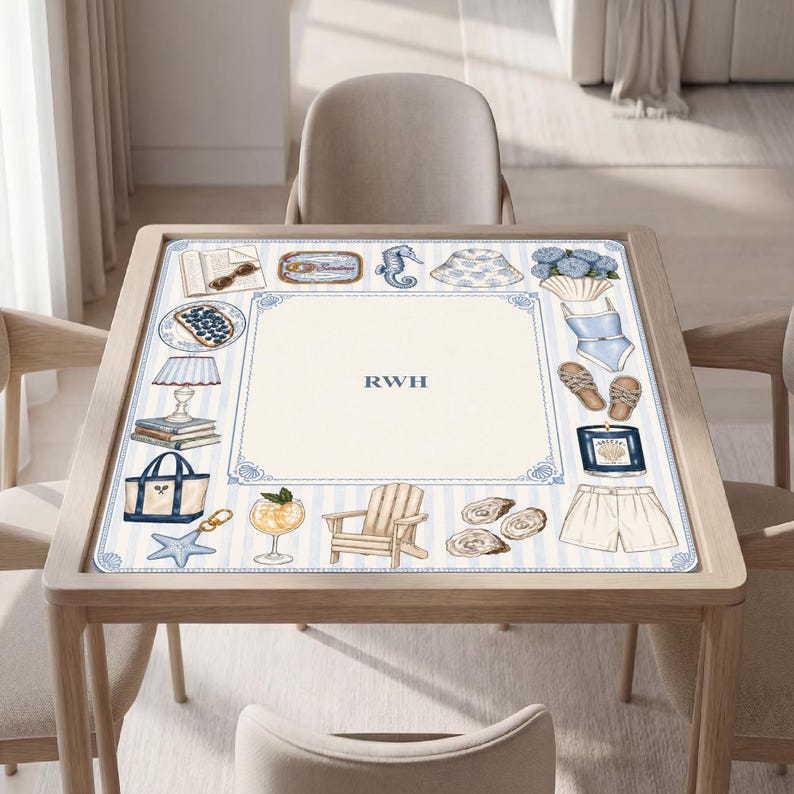 May include: A square table mat featuring a light blue and white striped border with illustrations of a book, sunglasses, seahorse, hat, flowers, swimsuit, sandals, candle, shorts, chair, cocktail, tote bag, and starfish, with the letters RWH in the center.