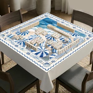 May include: A square table cover featuring a beach scene with blue and white striped umbrellas, seashells, and ocean waves. The surface is printed with a mahjong game layout, including multiple sets of ivory-colored mahjong tiles arranged in rows.