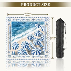 May include: A square beach towel featuring a watercolor print of blue and white striped umbrellas on a sandy shore with ocean waves. The towel measures 31.5 inches by 31.5 inches and includes a black carrying bag with a shoulder strap.