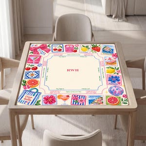 May include: A square mahjong mat featuring a cream-colored center with the letters RWH in red. The border displays colorful illustrations of cherries, lemons, grapefruit, cocktails, a beach bag, and Italian coastal scenes with text like Ciao bella.