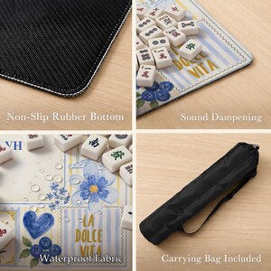 May include: A mahjong mat featuring a blue and yellow striped pattern with floral and heart illustrations, the text LA DOLCE VITA, a non-slip rubber bottom, waterproof fabric, sound dampening properties, and a black carrying bag with a strap.