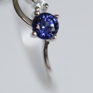 Petite Lab Created Blue Sapphire in an Accented Sterling Silver Swirl Setting