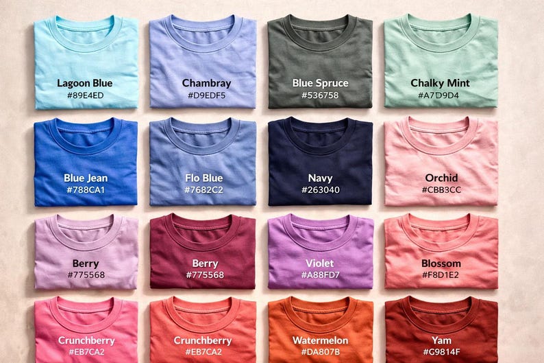 May include: A selection of folded t-shirts in a variety of colours, such as blue, green, pink, and purple. Each shirt displays a different colour name and a corresponding hex code. The shirts are neatly arranged, showcasing a range of hues.