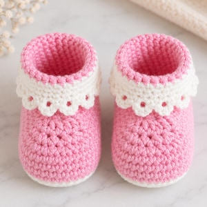 May include: A pair of handmade baby booties. The booties are crocheted in a soft pink yarn with a white scalloped trim around the opening. The booties are designed for infants and are a charming accessory.