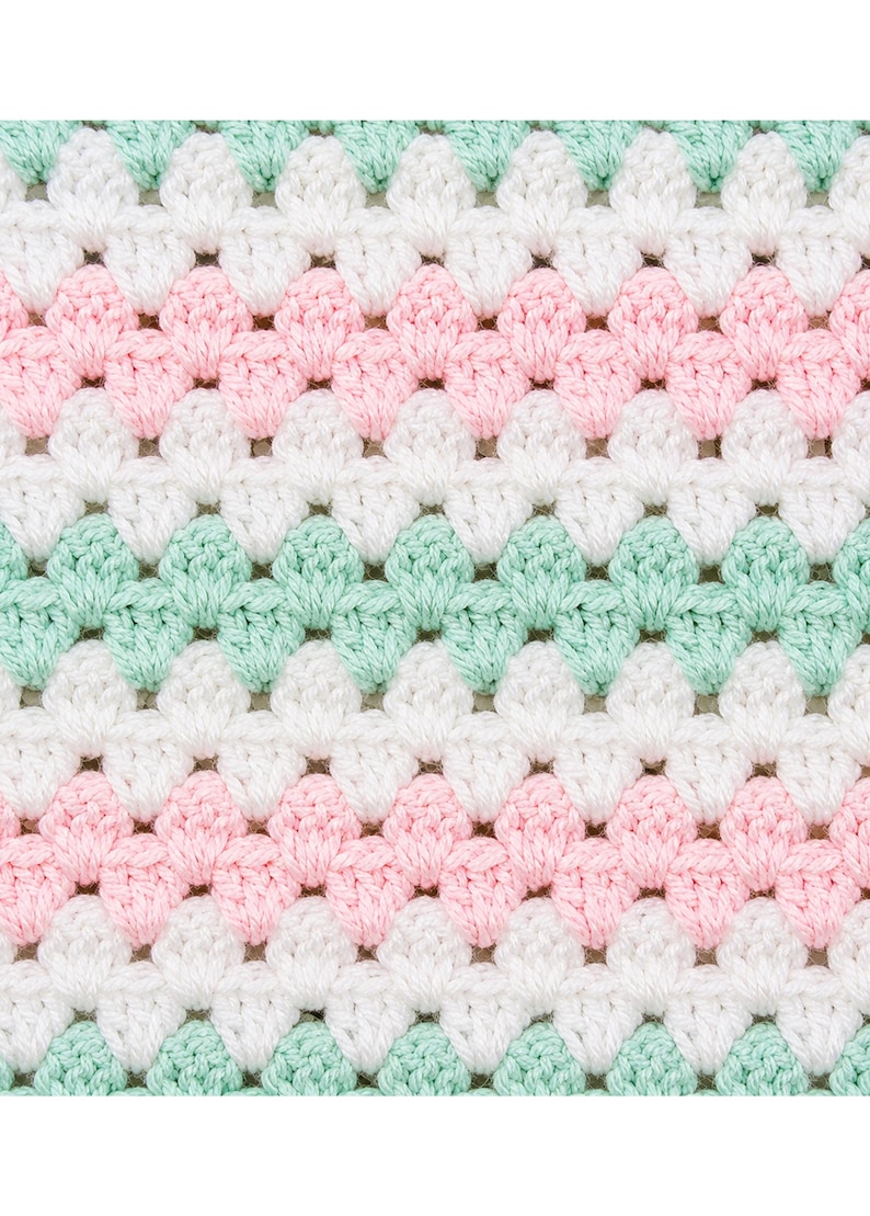 May include: A crocheted fabric featuring a repeating shell stitch pattern arranged in horizontal stripes. The design consists of alternating rows of soft pastel mint green, crisp white, and light baby pink yarn, creating a textured surface.