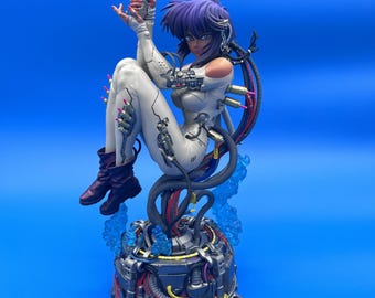 May include: A detailed anime-style figurine of a character with purple hair, wearing a white bodysuit with mechanical components and dark boots. The figure holds a silver handgun, is connected by black cables to a complex base, and features blue accents.