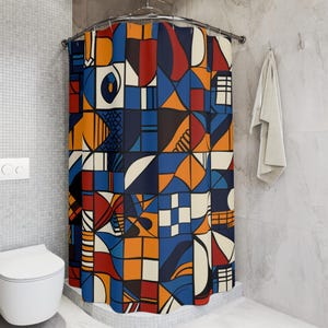 May include: A colorful shower curtain with an abstract geometric design. The pattern features squares, triangles, and other shapes in shades of blue, orange, red, and cream, creating a vibrant and modern look. The curtain is hanging in a bathroom setting.