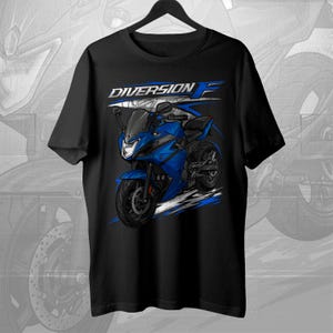 May include: Black t-shirt featuring a blue motorcycle graphic with the text "DIVERSION F" in white and blue. The motorcycle design includes details like the headlights, wheels, and body of the bike.