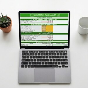 May include: A silver laptop displaying a spreadsheet titled Quarterly Tax Planner for Upwork Freelancers, featuring sections for income summary, business deductions, tax calculation, and quarterly payments with various numerical data entries.
