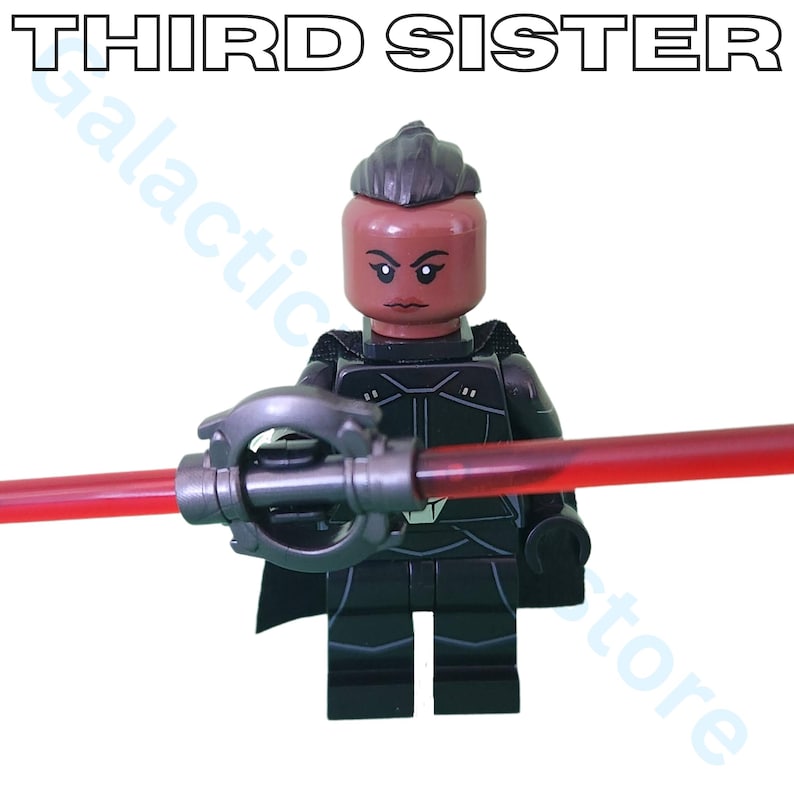 May include: A Lego figure of the Third Sister, a character from the Star Wars franchise, holding a red lightsaber. The figure is predominantly black with a dark brown head and the text "THIRD SISTER" above.
