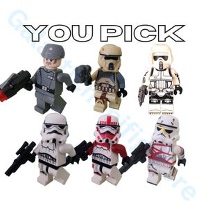 May include: A collection of six Star Wars Lego minifigures. The figures include a gray Imperial officer, a tan and gray scout trooper, and four different white and black stormtroopers. The text "YOU PICK" is at the top.