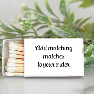May include: A white matchbox with a label that says "Add matching matches to your order". The matchbox is open and you can see the matches inside.