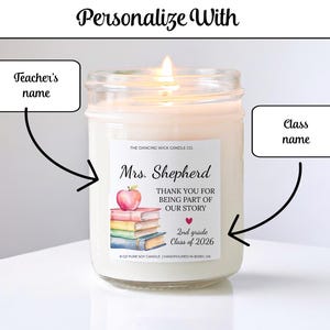 May include: A lit soy candle in a glass jar. The label reads "Mrs. Shepherd, THANK YOU FOR BEING PART OF OUR STORY, 2nd grade Class of 2026." An apple and books are illustrated on the label. The candle is hand-poured in Bixby, OK.