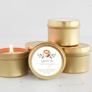 May include: Gold candle tins with a white label that says "Love is brewing" and features a watercolor illustration of a coffee cup. The label also includes the text "Thank you for showering Michelle with love 09.14.20xx".