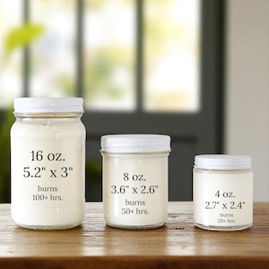 May include: Three clear glass jar candles with white lids, arranged by size. The largest is 16 oz. (5.2" x 3") with 100+ hrs. burn time, the middle is 8 oz. (3.6" x 2.6") with 50+ hrs., and the smallest is 4 oz. (2.7" x 2.4") with 20+ hrs.