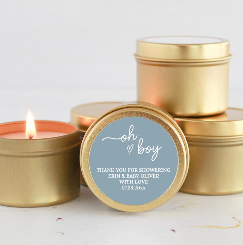 May include: Gold candle tins with a blue label that says "oh boy" with a heart and "Thank you for showering Erin & Baby Oliver with love 07.25.20xx"