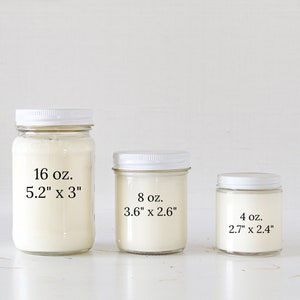 May include: Three glass candle jars with white lids and white wax. The jars are labeled with their size and dimensions in ounces and inches. The largest jar is 16 oz. and measures 5.2" x 3", the middle jar is 8 oz. and measures 3.6" x 2.6", and the smallest jar is 4 oz. and measures 2.7" x 2.4".