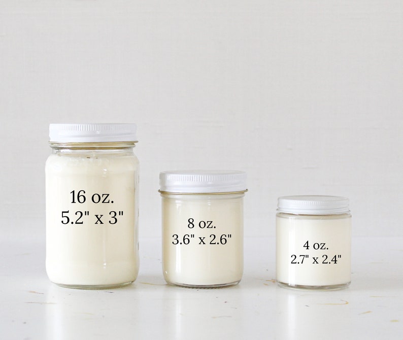 May include: Three glass candle jars with white lids and white wax. The jars are labeled with their size and dimensions in ounces and inches. The largest jar is 16 oz. and measures 5.2" x 3", the middle jar is 8 oz. and measures 3.6" x 2.6", and the smallest jar is 4 oz. and measures 2.7" x 2.4".
