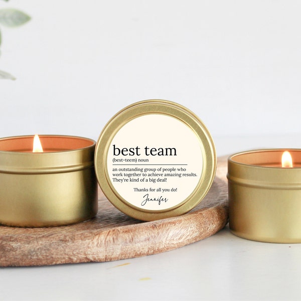 May include: Three gold candle tins with a white label. The label reads "best team (best-teem) noun an outstanding group of people who work together to achieve amazing results. They're kind of a big deal! Thanks for all you do! Jennifer"