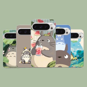 Op de afbeelding: Vijf smartphonehoesjes met diverse illustraties van het grijze, ronde personage Totoro met oren. De ontwerpen tonen Totoro in de regen, met een hoedje op, drinkend van een rode drank met watermeloen en in verschillende boslandschappen.