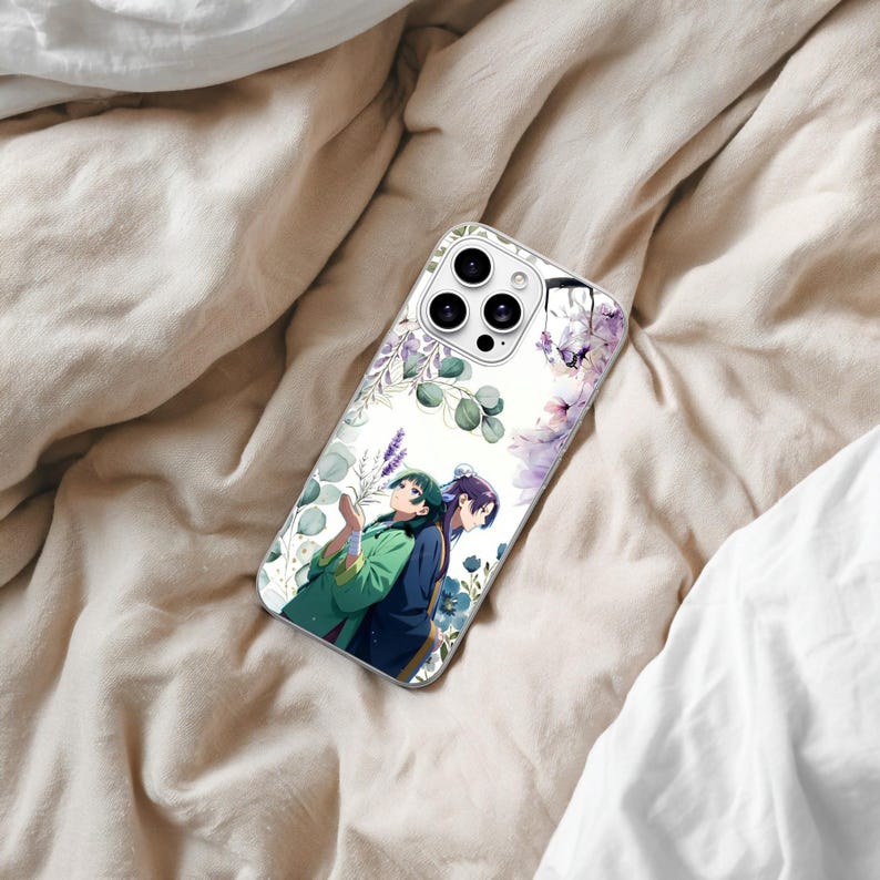 May include: A clear smartphone case featuring a printed illustration of two anime characters standing back-to-back amidst a background of purple lavender, green eucalyptus leaves, and soft pink floral accents surrounding the camera lens area.
