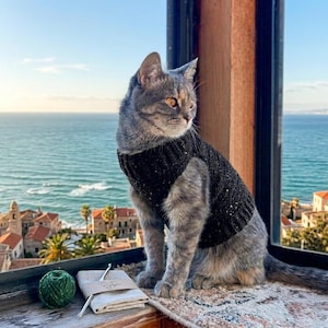 May include: A set of three ceramic mugs with a speckled, matte finish. Each mug features a different color: light blue, cream, and gray. The mugs have a simple, modern design and a comfortable handle. Perfect for coffee or tea.