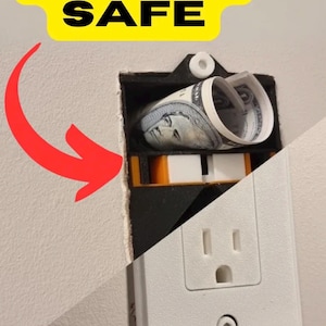 May include: A black and white wall outlet diversion safe with a removable white faceplate. The interior compartment is black with orange accents and contains a rolled-up US dollar bill. The text SECRET SAFE is displayed above.