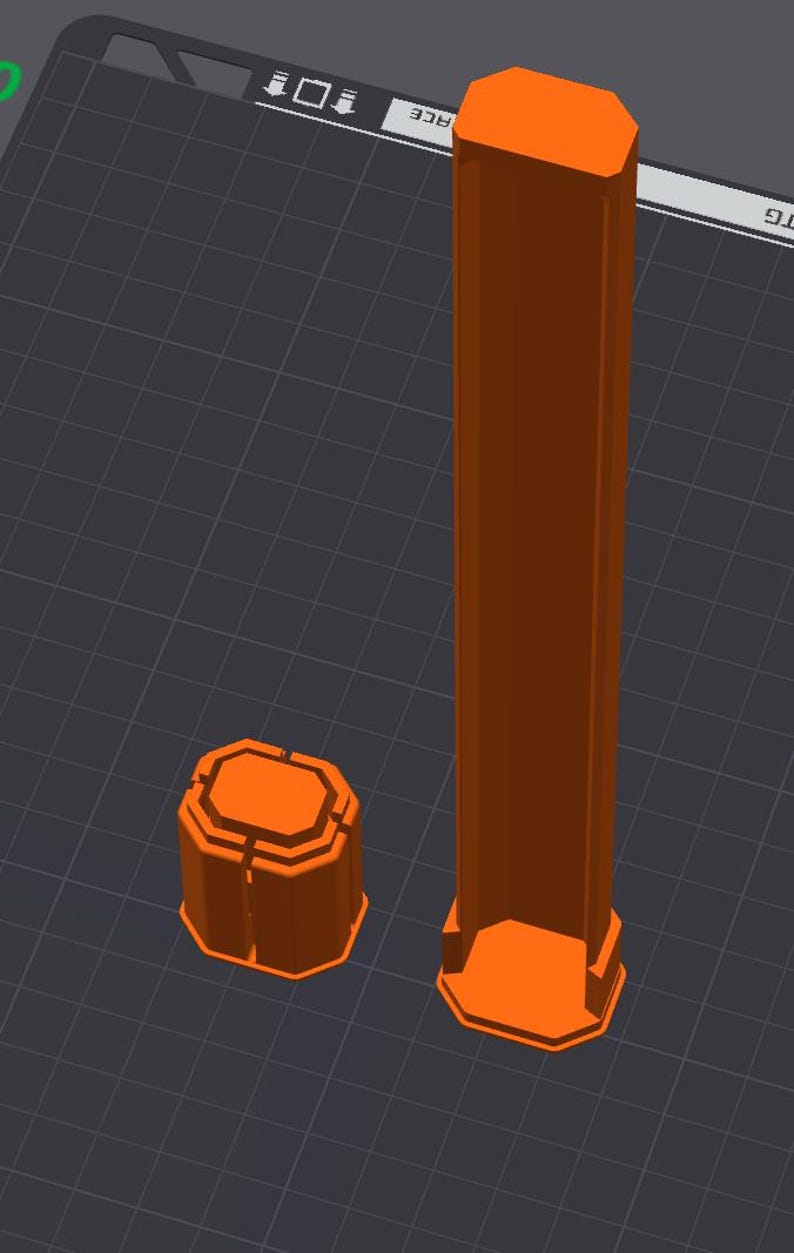 May include: Two orange, geometric 3D-printed objects. One is a tall, rectangular prism with an octagonal base and top. The other is a shorter, octagonal prism. Both objects are on a dark gray surface with a grid pattern.