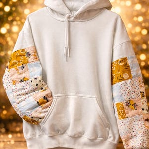 May include: A set of three ceramic mugs with a speckled, matte finish in cream, light grey, and dark grey. Each mug has a simple, minimalist design and a rounded handle.