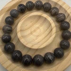 May include: A rustic wooden sign with the text "Welcome to our home" in white lettering. The sign features a distressed finish and a simple, inviting design, perfect for a front porch or entryway.