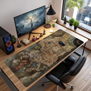 May include: A white ceramic mug with a black handle and the text "But First, Coffee" in a black, handwritten-style font. The mug is on a white surface.