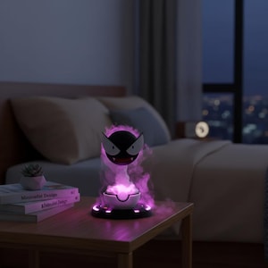 May include: A black and white character lamp with a purple glow, emitting a smoky effect. The lamp sits on a wooden nightstand next to a bed. The lamp's design is reminiscent of a popular animated character.