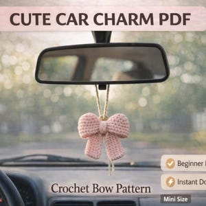 May include: A light pink crocheted bow car charm hanging from a car's rearview mirror. The image includes text that reads "CUTE CAR CHARM PDF" and "Crochet Bow Pattern". The charm is suspended in front of a blurred background of trees and a car dashboard.