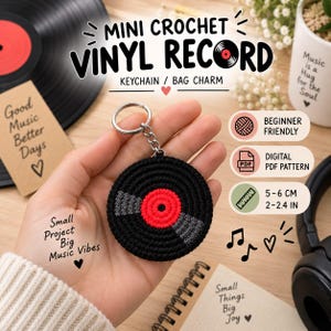 May include: A circular crochet vinyl record keychain featuring a black outer ring, a red center, and two grey accents. The item includes a silver metal split ring and chain. Text on the image reads MINI CROCHET VINYL RECORD, KEYCHAIN / BAG CHARM, BEGINNER FRIENDLY, DIGITAL PDF PATTERN, and 5-6 CM 2-2.4 IN.