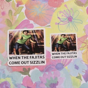 May include: Two stickers with the text "WHEN THE FAJITAS COME OUT SIZZLIN". The stickers feature a person wearing a green shirt and jeans, with arms raised in a celebratory pose. The stickers are on a floral background.