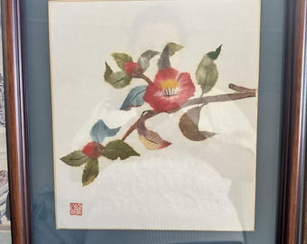 Japanese washi paper art camellia flowers (tsubaki) on a branch.