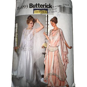 May include: A Butterick B4093 sewing pattern envelope featuring illustrations of two floor-length dresses. One dress is white with a sheer overlay and lace detail, while the other is peach with draped sleeves and a decorative waist panel.