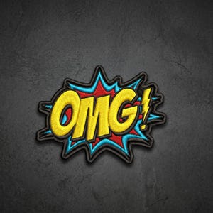 May include: An embroidered patch featuring the text OMG in bold yellow letters with a black outline. The text is set against a red and blue comic book style explosion shape with a black border and a small yellow lightning bolt icon at the end.