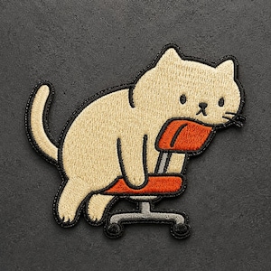 May include: An embroidered patch featuring a light beige cat sitting on an orange office chair with a gray base. The cat has a simple black outline, two black eyes, a small black nose, and whiskers. The design is rendered in thread.
