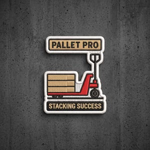 May include: A rectangular embroidered patch featuring a red pallet jack carrying tan boxes. The top text reads PALLET PRO and the bottom text reads STACKING SUCCESS. The design is outlined in white thread against a dark gray textured background.