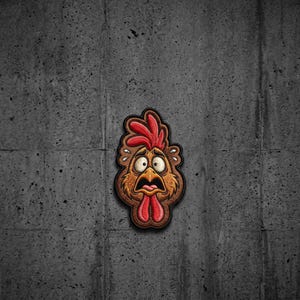 May include: A cartoon-style patch featuring the head of a brown chicken with a shocked expression, wide eyes, and an open beak. The chicken has a bright red comb and wattle, with small white sweat drops depicted around its head on a dark outline.