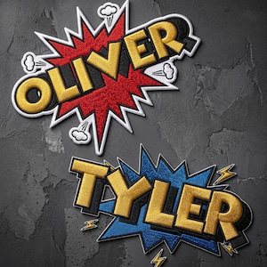 May include: Two embroidered patches featuring comic book style speech bubbles. The top patch displays the name OLIVER in gold letters with black outlines on a red starburst background. The bottom patch shows TYLER in gold on a blue starburst.