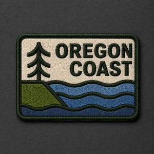 May include: A rectangular embroidered patch featuring a dark green pine tree on a cream background, with the text OREGON COAST in dark green letters above stylized blue ocean waves and a green grassy cliff edge, all bordered in dark green.