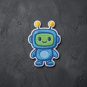 May include: An embroidered patch featuring a cartoon robot with a bright green face, a blue body, and two yellow antennae with round tips. The robot has a simple smiling mouth, two oval eyes, and a circular belly patch, all outlined in white thread.