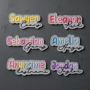 May include: Six custom embroidered name patches featuring puffy, colorful block-letter first names paired with black cursive last names. The names include Sawyer Evans, Eleanor Reid, Sebastian Gomes, Amelia Hayes, Anyname Lastname, and Jordan Taylor.