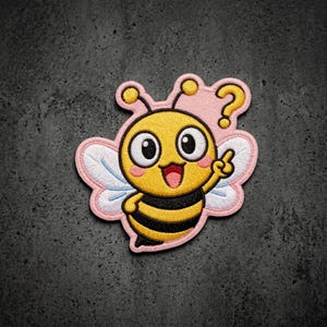 May include: An embroidered patch featuring a cartoon bee with a yellow and black striped body, large white eyes, and pink cheeks. The bee has white wings, is pointing one finger upward, and has a yellow question mark floating above its head.