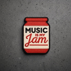 May include: An embroidered patch shaped like a jar with a red lid and base. The center label is cream-colored with black text reading MUSIC and red text reading IS MY Jam, featuring a horizontal red line underneath the word Jam, all outlined in black.