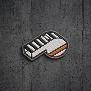 May include: An embroidered patch shaped like the letter P, featuring a black and white piano key pattern on the vertical stem and a white rounded section with a horizontal orange stripe on the right side, all outlined in a dark gray border.